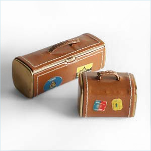 compact and lipstick cases in the forms of miniature luggage