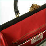 Sizable, black leather bag with ribbon detail