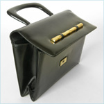 black leather handbag with gold bamboo accen
