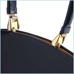 Sleek, navy leather handbag with unique clasp