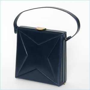 navy blue leather handbag with a quilted four point star