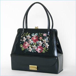 black handbag with needlepoint panels