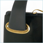 black leather handbag with exaggerated taper to arching handle